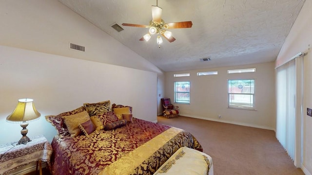 bedroom featuring ceiling fan, visible vents, vaulted ceiling, and carpet