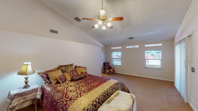 carpeted bedroom with ceiling fan, vaulted ceiling, a textured ceiling, and visible vents