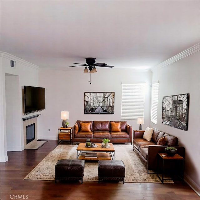12851 Oakdale St, Eastvale, CA 92880 - living room featuring wood finished floors, ornamental molding, baseboards, a ceiling fan, and a tile fireplace