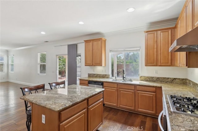 12851 Oakdale St, Eastvale, CA 92880 - kitchen featuring appliances with stainless steel finishes, a sink, dark wood-style flooring, a breakfast bar, and crown molding
