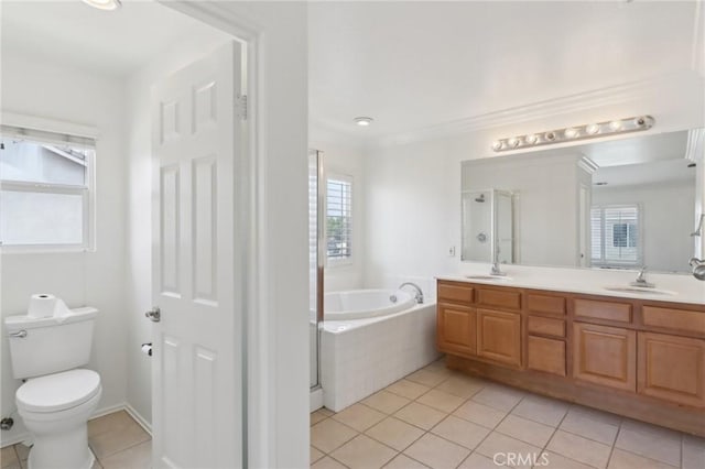 12851 Oakdale St, Eastvale, CA 92880 - bathroom featuring tile patterned floors, a bath, double vanity, a stall shower, and toilet