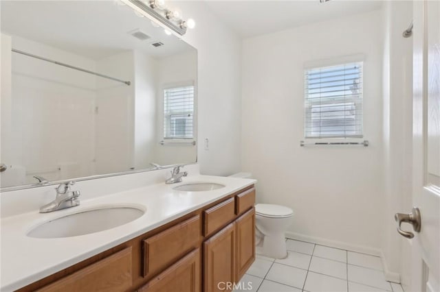 12851 Oakdale St, Eastvale, CA 92880 - full bath with toilet, tile patterned floors, double vanity, a shower, and baseboards