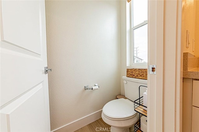 11751 Florence Ave, Santa Fe Springs, CA 90670 - bathroom with baseboards, toilet, and wood finished floors