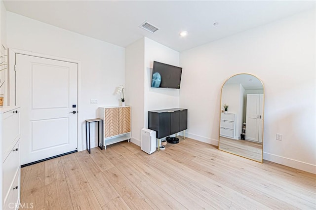 11751 Florence Ave, Santa Fe Springs, CA 90670 - interior space featuring light wood-style floors, arched walkways, baseboards, and visible vents