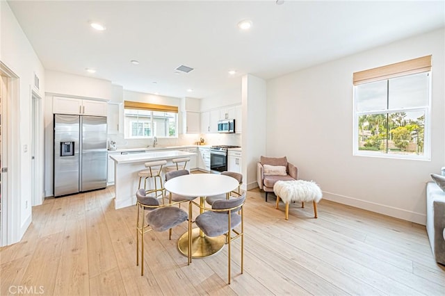 11751 Florence Ave, Santa Fe Springs, CA 90670 - dining room featuring recessed lighting, baseboards, light wood-type flooring, and visible vents