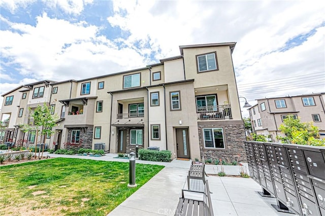 11751 Florence Ave, Santa Fe Springs, CA 90670 - townhome / multi-family property featuring central AC, a front lawn, stucco siding, and stone siding