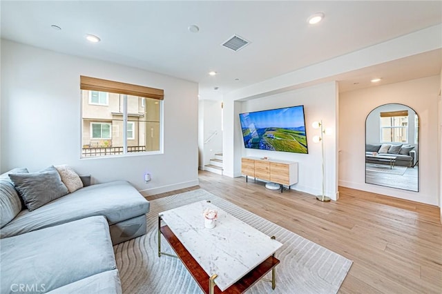 11751 Florence Ave, Santa Fe Springs, CA 90670 - living area with visible vents, baseboards, light wood-style floors, stairway, and recessed lighting