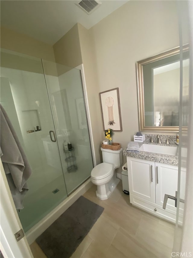 full bathroom with visible vents, vanity, toilet, and a shower stall