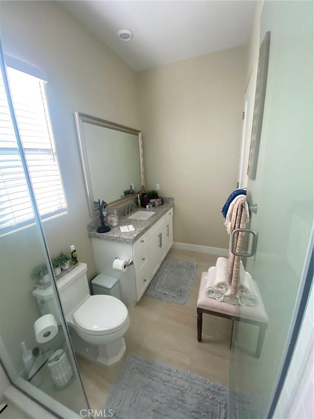 bathroom with vanity, tile patterned flooring, and toilet