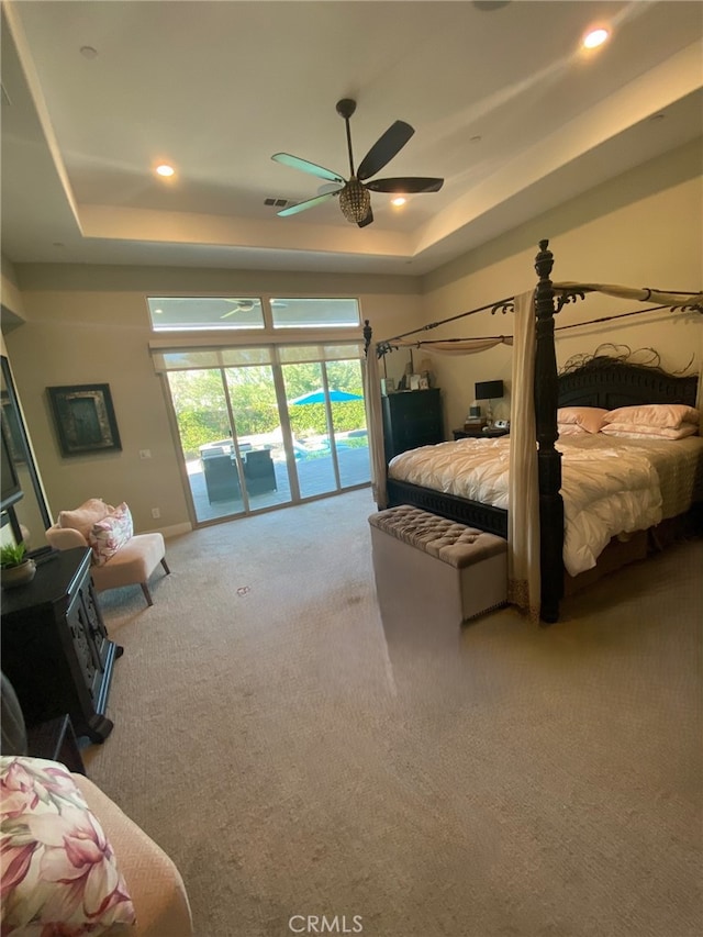 bedroom featuring recessed lighting, carpet, access to exterior, and a raised ceiling