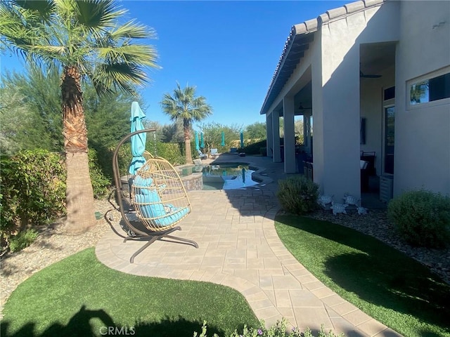 exterior space featuring an outdoor pool and a patio area
