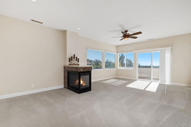 unfurnished living room featuring carpet floors, baseboards, and visible vents