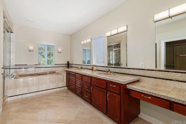 bathroom with a garden tub, tile patterned flooring, double vanity, a shower stall, and a sink