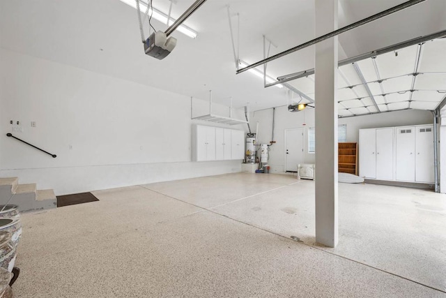 garage featuring strapped water heater and a garage door opener