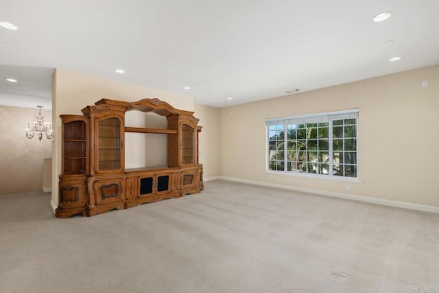 unfurnished living room with carpet floors, visible vents, baseboards, recessed lighting, and a notable chandelier