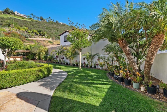 exterior space with fence and a yard