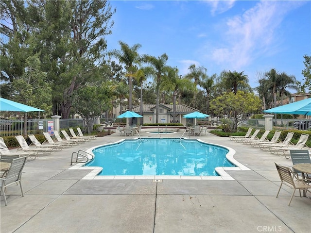 pool featuring fence and a patio area