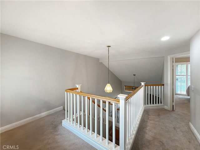 staircase with vaulted ceiling, baseboards, and carpet flooring