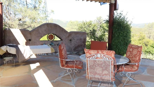 view of patio featuring a mountain view and outdoor dining area