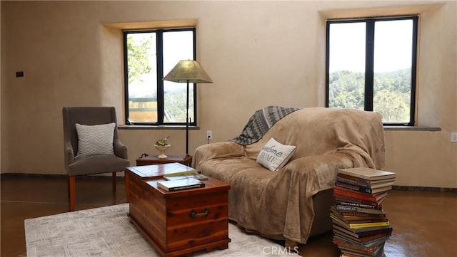 sitting room with plenty of natural light and baseboards