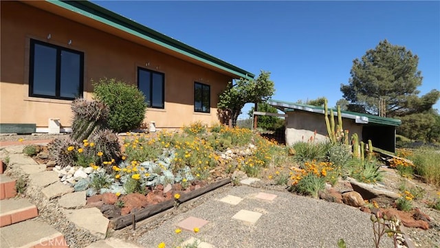 view of side of property with stucco siding