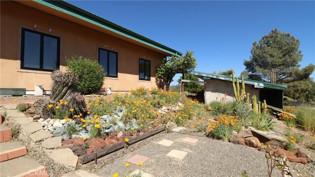 view of side of property featuring stucco siding