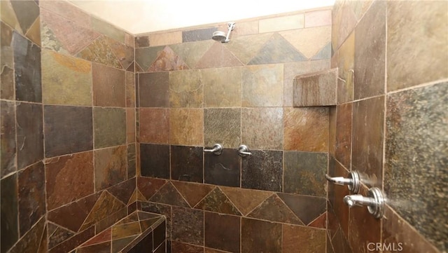 interior details featuring tiled shower