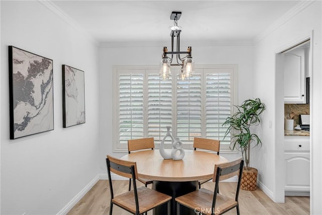 dining space featuring ornamental molding, a wealth of natural light, and light wood-style flooring