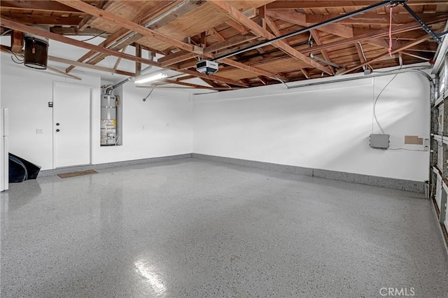 garage featuring water heater and a garage door opener