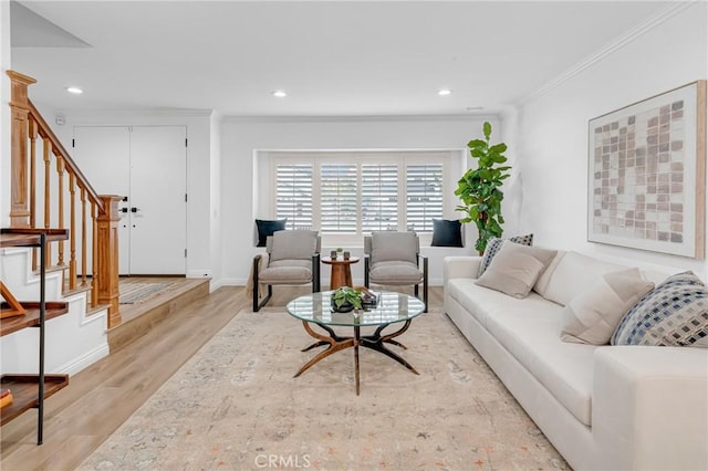 living area featuring crown molding, recessed lighting, stairs, and light wood finished floors
