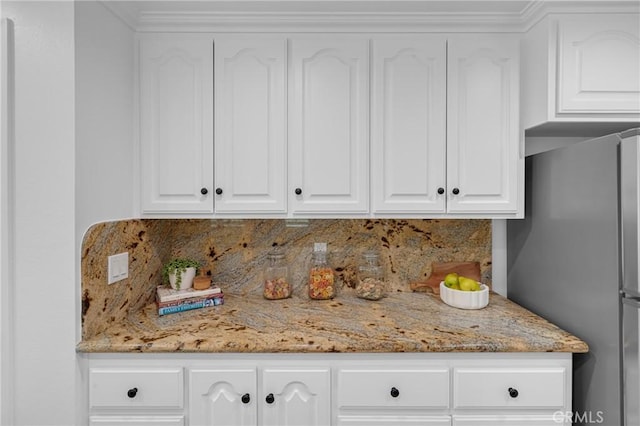 interior details featuring freestanding refrigerator and backsplash