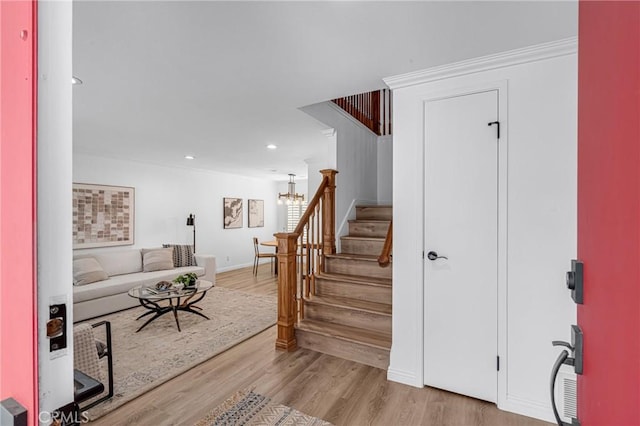 interior space featuring a chandelier, light wood-style flooring, stairs, recessed lighting, and baseboards