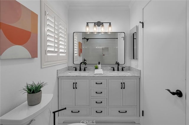 bathroom featuring a sink, ornamental molding, double vanity, and a shower