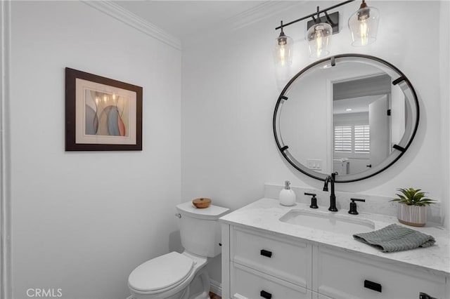 half bath featuring crown molding, vanity, and toilet