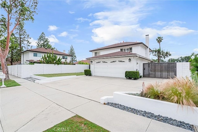 view of home's exterior featuring fence, driveway, a chimney, and a garage