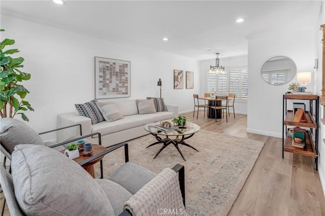 living room featuring recessed lighting, baseboards, light wood-type flooring, and a chandelier
