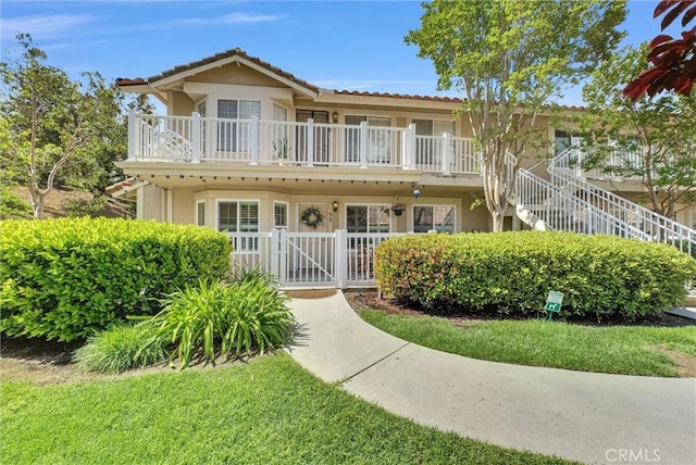 19801 Meadow Ridge Dr Unit 35, Trabuco Canyon, CA 92679 - view of front of property featuring a gate, a fenced front yard, stucco siding, and stairway