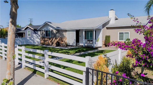 12748 Paramount Blvd, Downey, CA 90242 - single story home with covered porch, a fenced front yard, a chimney, and stucco siding