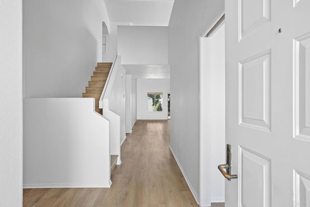 4905 Alicante Way, Oceanside, CA 92056 - corridor with wood finished floors, stairway, and baseboards