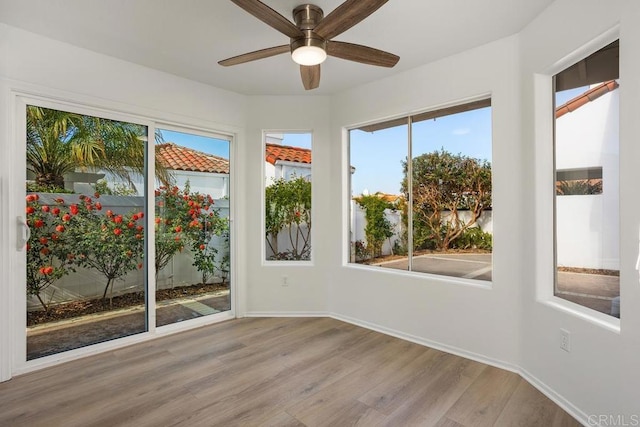 4905 Alicante Way, Oceanside, CA 92056 - unfurnished sunroom with wood finished floors, baseboards, and healthy amount of natural light