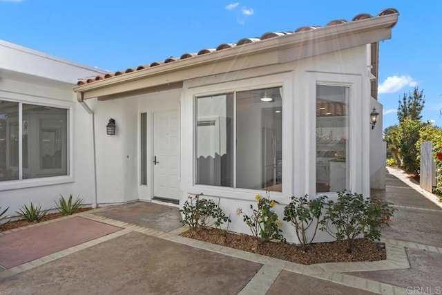 4905 Alicante Way, Oceanside, CA 92056 - property entrance with a tile roof, a patio, and stucco siding