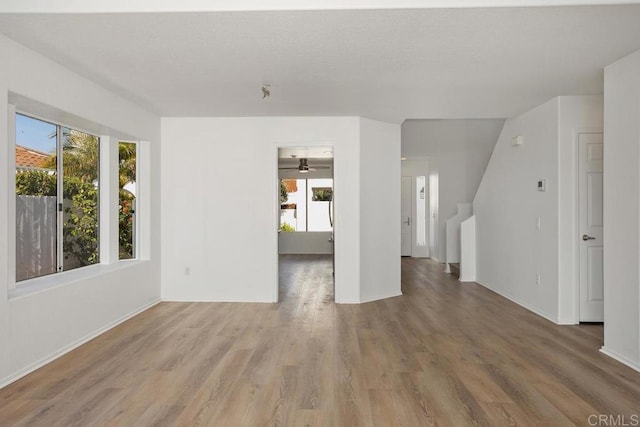 4905 Alicante Way, Oceanside, CA 92056 - unfurnished living room with wood finished floors, baseboards, and ceiling fan