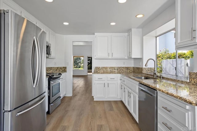4905 Alicante Way, Oceanside, CA 92056 - kitchen featuring stainless steel appliances, white cabinetry, light wood-style floors, light stone countertops, and recessed lighting