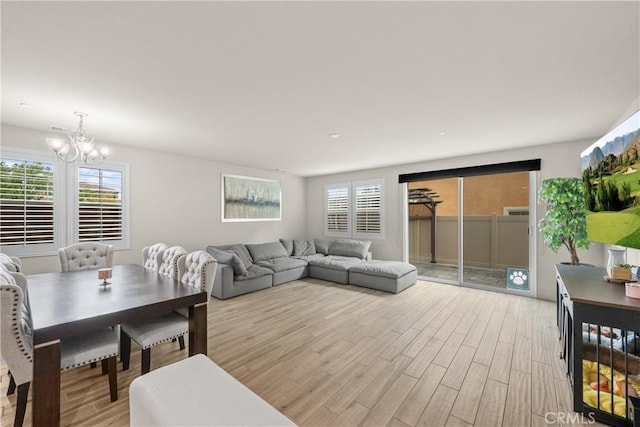 living area featuring an inviting chandelier and light wood finished floors