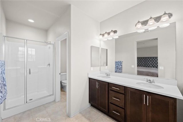 ensuite bathroom with a sink, ensuite bathroom, and a stall shower