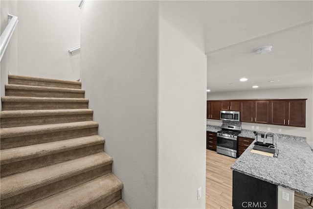 stairway featuring recessed lighting and wood finished floors
