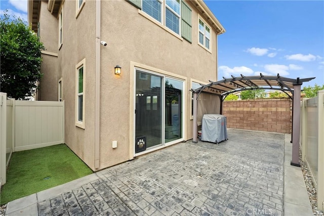 view of patio featuring area for grilling, a pergola, and a fenced backyard