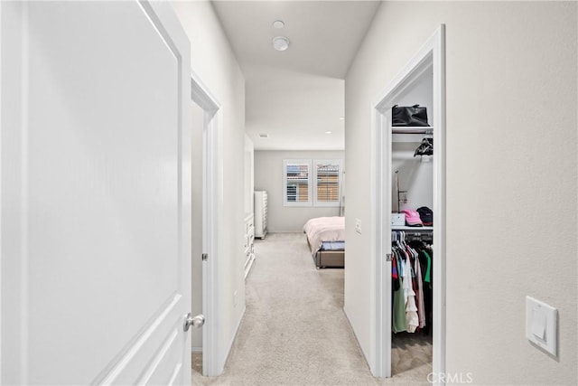 hall featuring light carpet