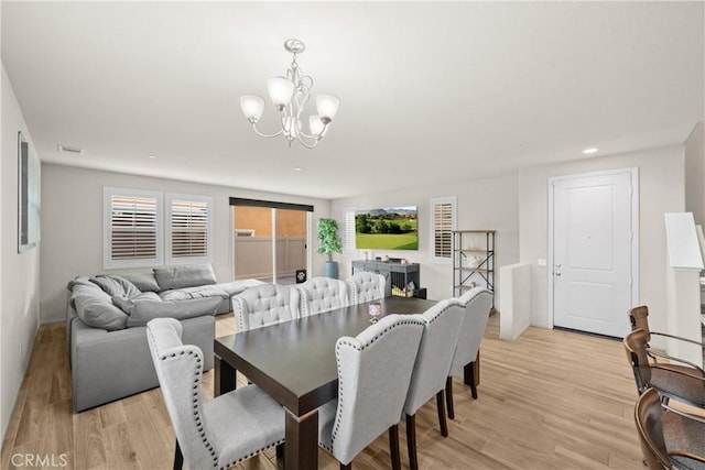 dining space featuring recessed lighting, an inviting chandelier, light wood-style flooring, and visible vents