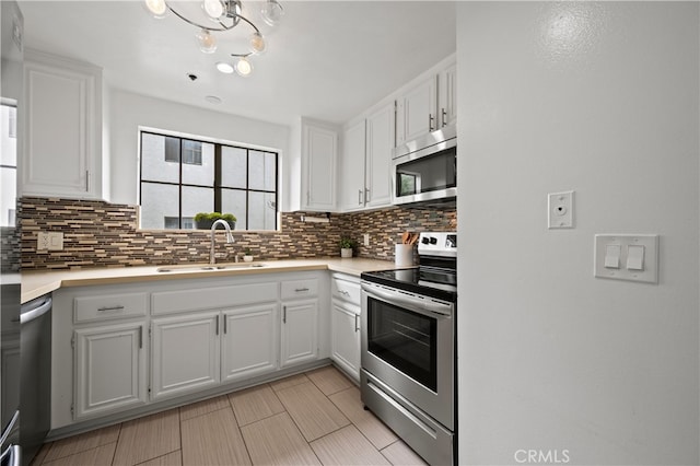 730 W 4th St Unit 307, Long Beach, CA 90802 - kitchen with white cabinetry, appliances with stainless steel finishes, decorative backsplash, and a sink